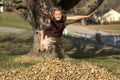 Girl Jumping into Leaf Pile Royalty Free Stock Photo