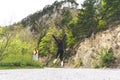 Girl jumping in the middle of the road in a national park Durmitor, Montenegro. Red Head jump for happiness and freedom Royalty Free Stock Photo