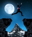 Girl jumping over the gap in night. Royalty Free Stock Photo