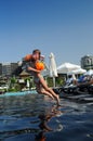 Girl jumping into pool