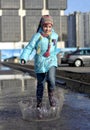 Girl jumping in the puddles Royalty Free Stock Photo