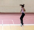 Girl jumping on roller skates during a figure skating competition