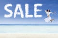 Girl jumping and sale cloud on white sand beach Royalty Free Stock Photo