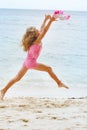 Girl jumping on sand beach Royalty Free Stock Photo