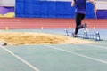 Girl jumping into sandpit on long jump competition Royalty Free Stock Photo