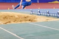 Girl jumping into sandpit on long jump competition Royalty Free Stock Photo