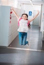happy girl jumping in school corridor Royalty Free Stock Photo