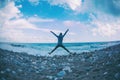 Girl jumping on the sea coast at sunset Royalty Free Stock Photo