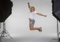 Girl jumping on set of a photoshoot Royalty Free Stock Photo