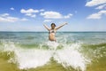 Girl jumping and splashing in the waves of the sea Royalty Free Stock Photo