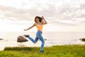 Girl jumping at sunset against the background of the sea Royalty Free Stock Photo