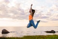 girl jumping at sunset against the background of the sea Royalty Free Stock Photo