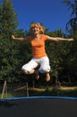 Girl Jumping on Trampoline Royalty Free Stock Photo