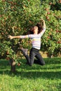 Girl jumping under apple tree Royalty Free Stock Photo