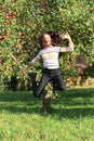 Girl jumping under apple tree Royalty Free Stock Photo