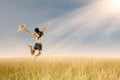 Girl jumping in wheat field Royalty Free Stock Photo