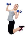 Girl jumps with dumbbells Royalty Free Stock Photo