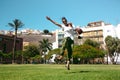 Girl jumps happy in the grass in the park Royalty Free Stock Photo