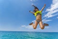 Girl jumps over the ocean