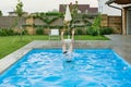 Girl jumps into the pool, photo shows the legs up sticking out of the water Royalty Free Stock Photo