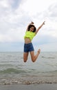 Girl jumps very high to manifest joy and enthusiasm by the