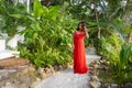 Girl in the jungle walks along a tropical trail