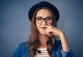 This girl just wants to have fun. a comical young woman posing with a mustache drawn on her finger in studio.