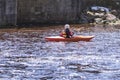 A woman on a mountain river is engaged in rafting. A girl is kayaking down a mountain river.girl in a kayak, side view Royalty Free Stock Photo