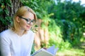 Girl keen on book keep reading. Bestseller top list concept. Woman blonde take break relaxing in park reading book. Girl Royalty Free Stock Photo