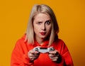 Blonde girl keen plays with a joystick Royalty Free Stock Photo