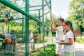 Girl keeps records and a boy takes photos of lemurs in the zoo