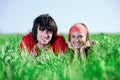 Girl in kerchief with boy on grass