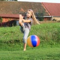 Girl kicking inflating ball Royalty Free Stock Photo