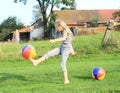 Girl kicking inflating balls Royalty Free Stock Photo