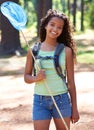 Girl, kid and butterfly net in forest for adventure and hiking outdoor, smile in portrait and backpacking. Travel, young Royalty Free Stock Photo