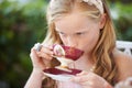 Girl, kid and drinking tea in garden with party for birthday, celebration and playing outdoor in home. Person, child and