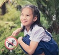 Girl kid pointing at no dog allow signage in a garden