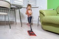 Little girl doing wet cleaning of the floor at home Royalty Free Stock Photo