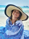 Girl kids on the beach with a big hat