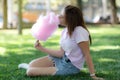 A girl on a kirtag with cotton candy. fun and joy of fair