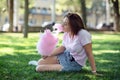 A girl on a kirtag with cotton candy. fun and joy of fair