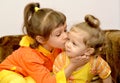 The girl kisses the younger little sister. Portrait Royalty Free Stock Photo