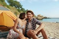 Girl kissing her pleased guy on sandy sea beach Royalty Free Stock Photo