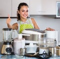 Girl with kitchen appliances at home.