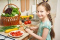 Girl in kitchen interior, vegetables and fresh fruits in basket, healthy nutrition concept Royalty Free Stock Photo