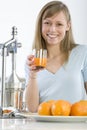 Girl in the kitchen with juicy orange Royalty Free Stock Photo