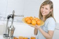 Girl in the kitchen with juicy orange Royalty Free Stock Photo