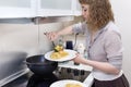 Girl in the kitchen prepares pasta with chicken, mushrooms and p