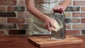 Girl on the kitchen rubs cheese on the grater