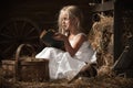 Girl with a kitten on hay